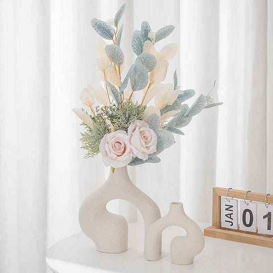 Minimalist ceramic vase with floral arrangement for home decor.