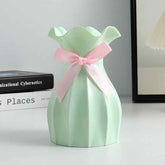 Nordic durable plastic flower vase with pink ribbon, perfect modern home accent for stylish decor.