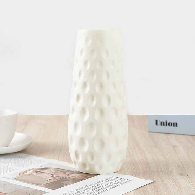 Nordic durable plastic flower vase on a table with modern design and textured surface.