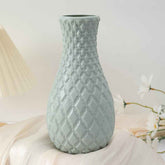 Nordic durable plastic flower vase in soft green color with textured design.