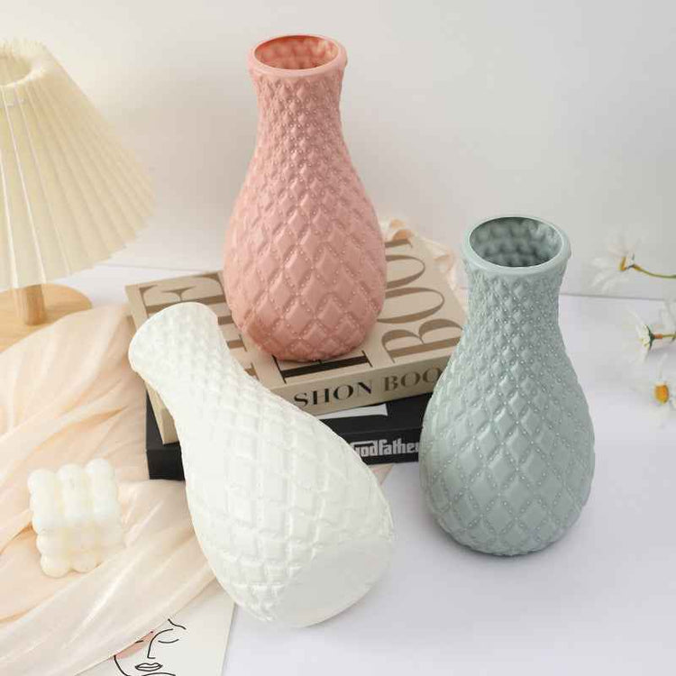 Nordic durable plastic flower vase in three colors on a table with modern decor.