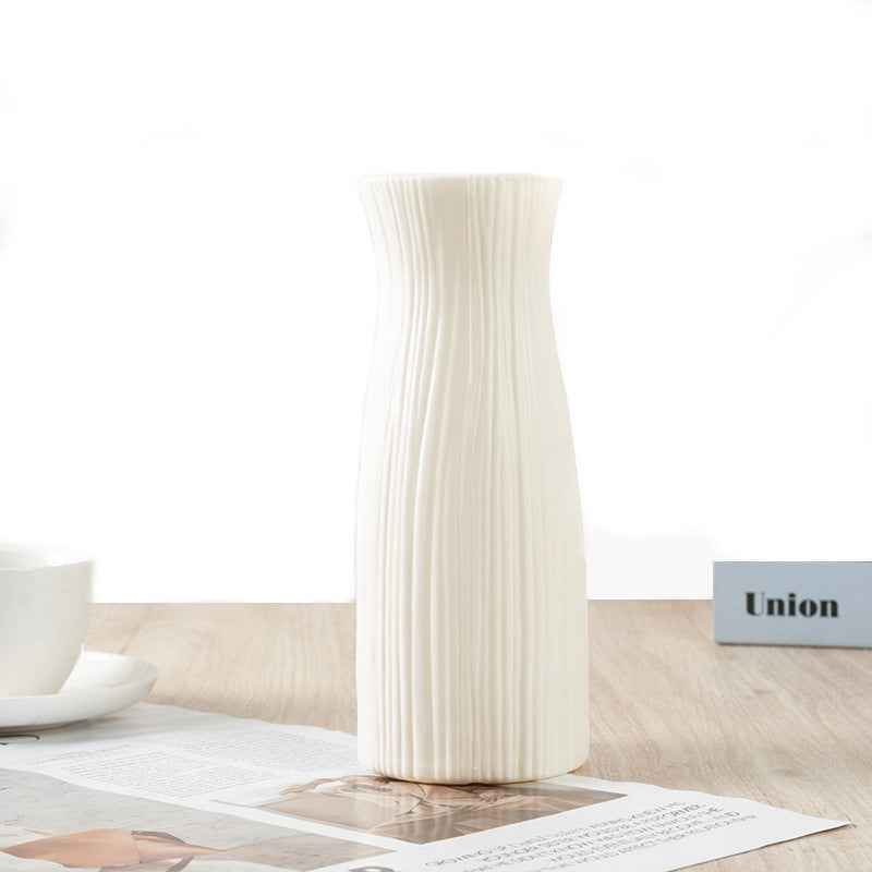Nordic durable plastic flower vase in white on a wooden table for modern home accent decoration.