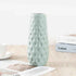 Nordic durable plastic flower vase in light blue with modern design and textured surface.