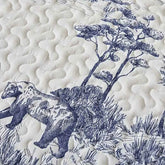 Close-up of quilted fabric featuring bear and tree design in navy blue and cream colors.
