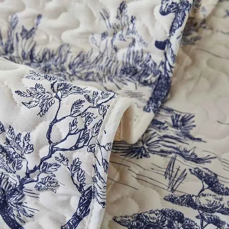 Close-up of a beautiful quilted fabric featuring a blue and white nature print.