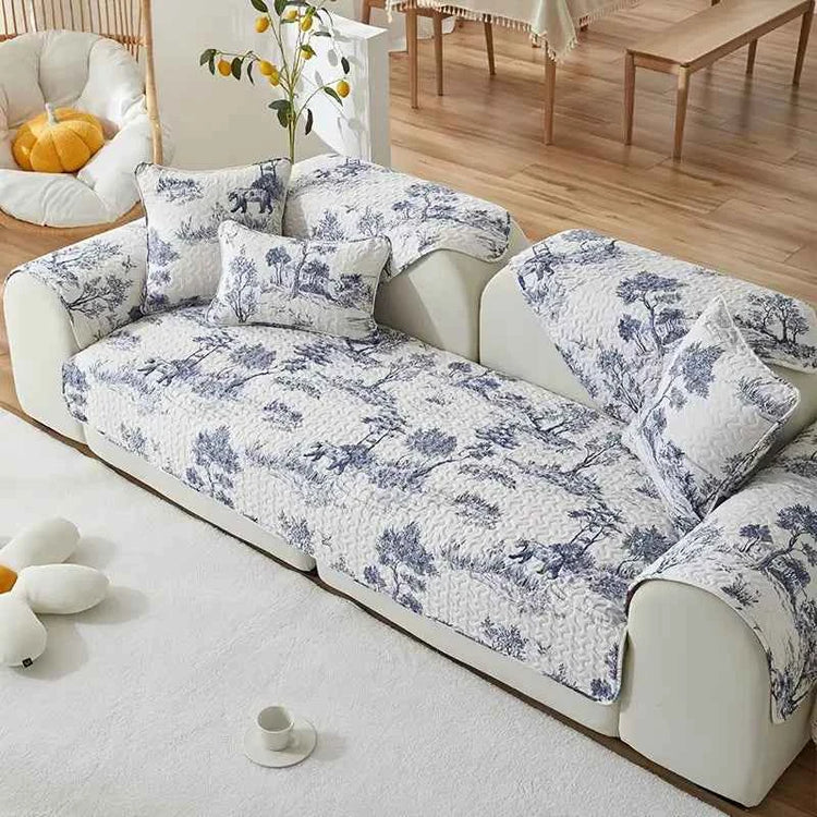 Universal Sofa Cover in stretch fabric for protection and style on a modern sofa with decorative cushions.